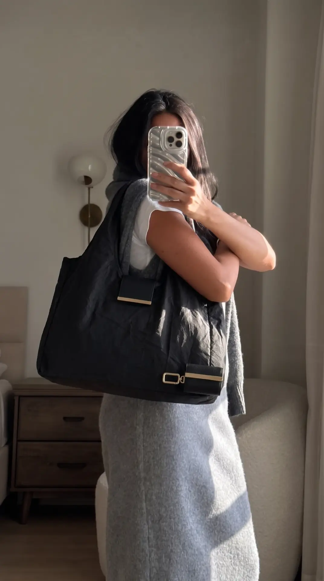 The cliptote worn over the shoulder, opened out as a full-size tote